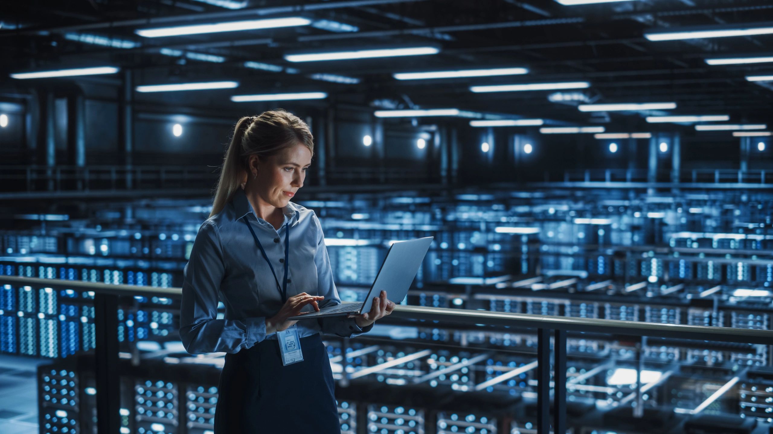 Data Center Female It Specialist Using Laptop. Server